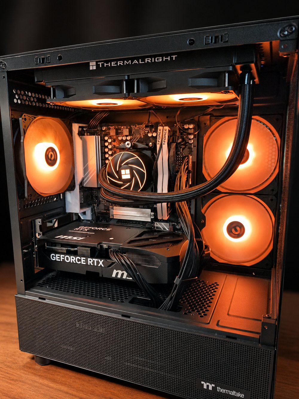 Our demo PC with the side panel off, showing the graphics card, liquid cooler and glowing fans